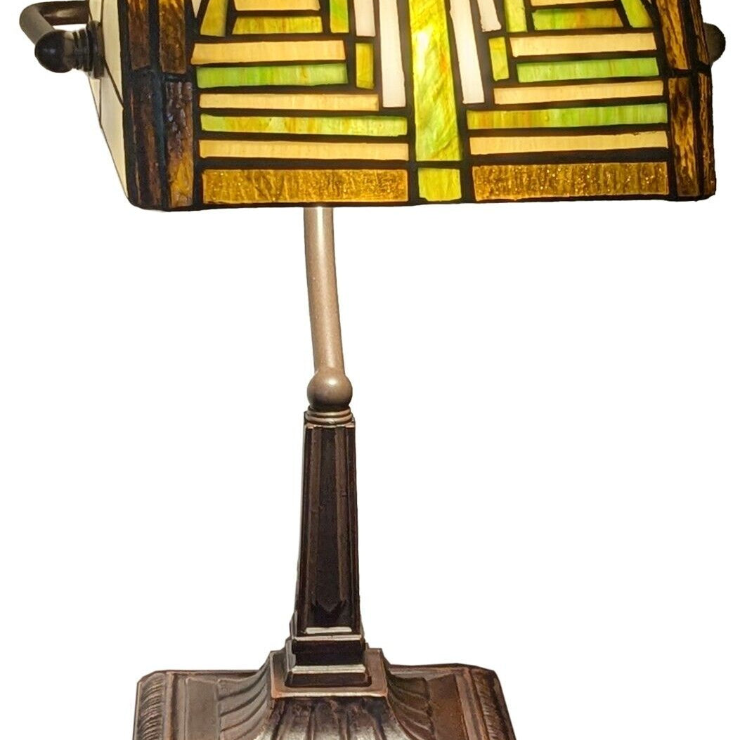Decorative table lamp with stained glass shade on a white background