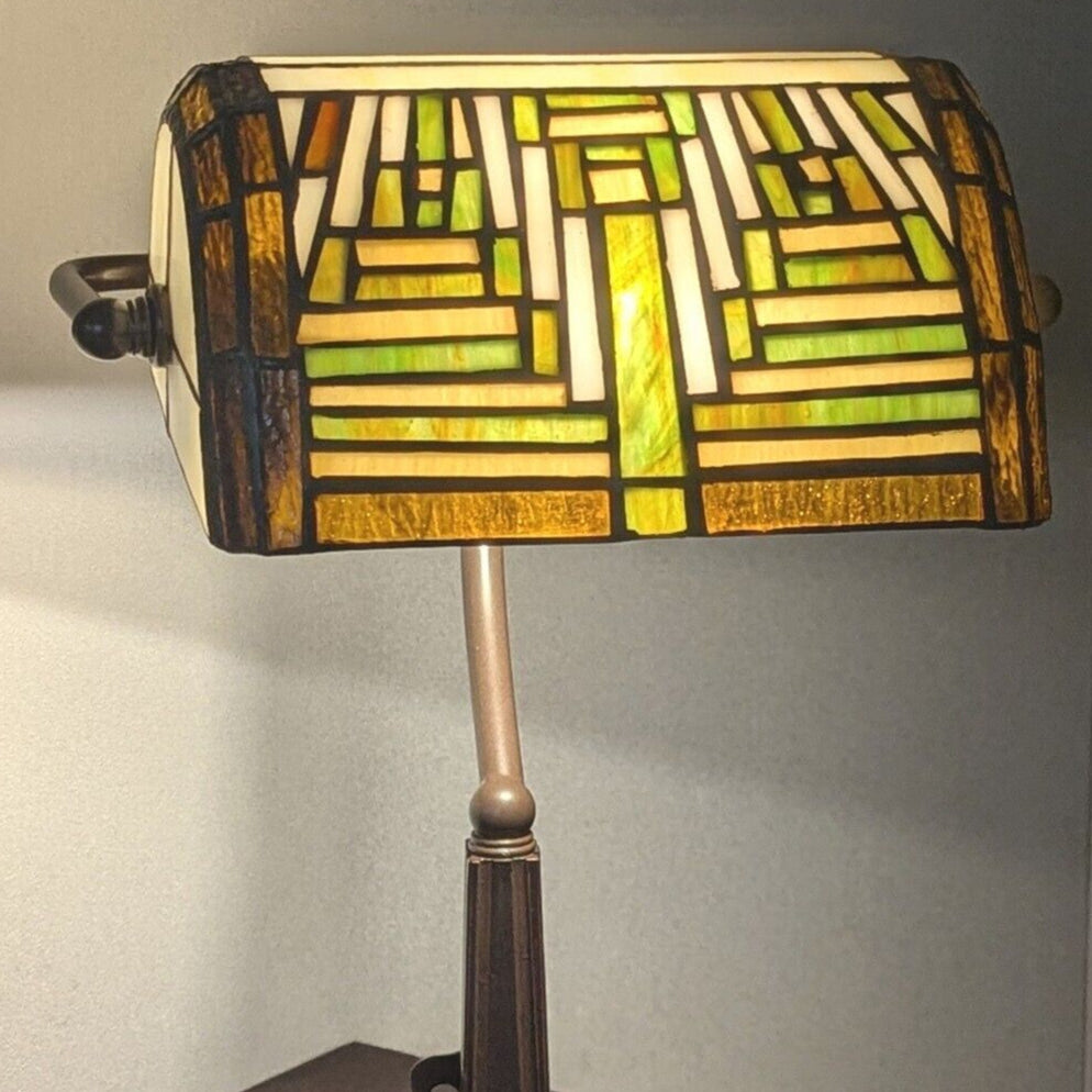 Decorative lamp with stained glass shade on a plain background