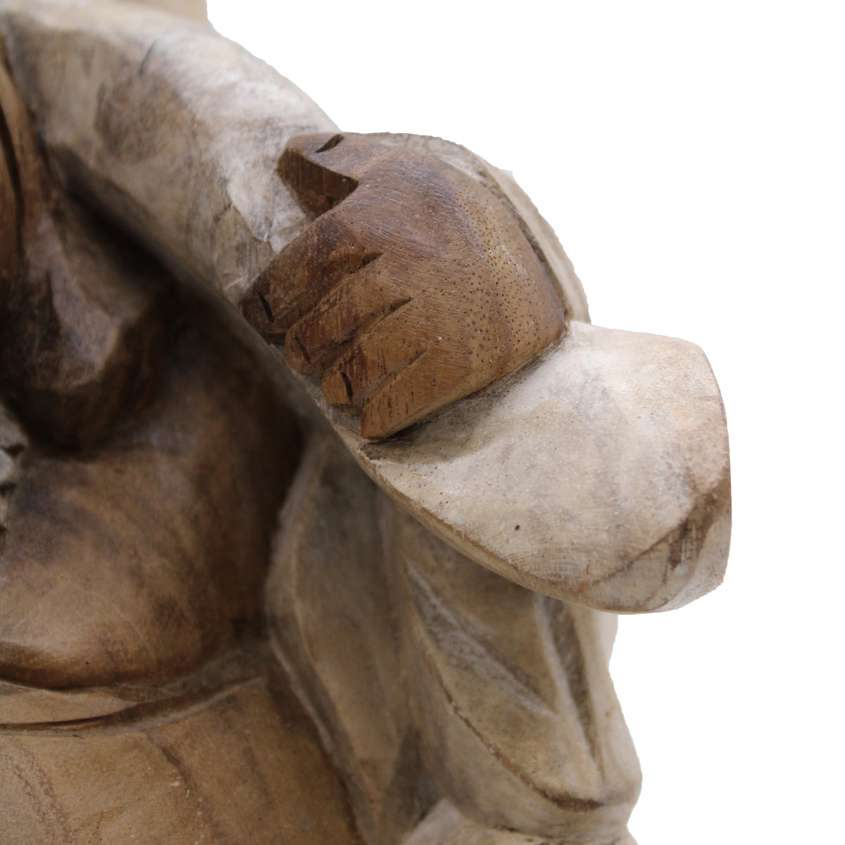 Close-up of a wooden sculpture of a Buddha's hand on their travel bag against a white background