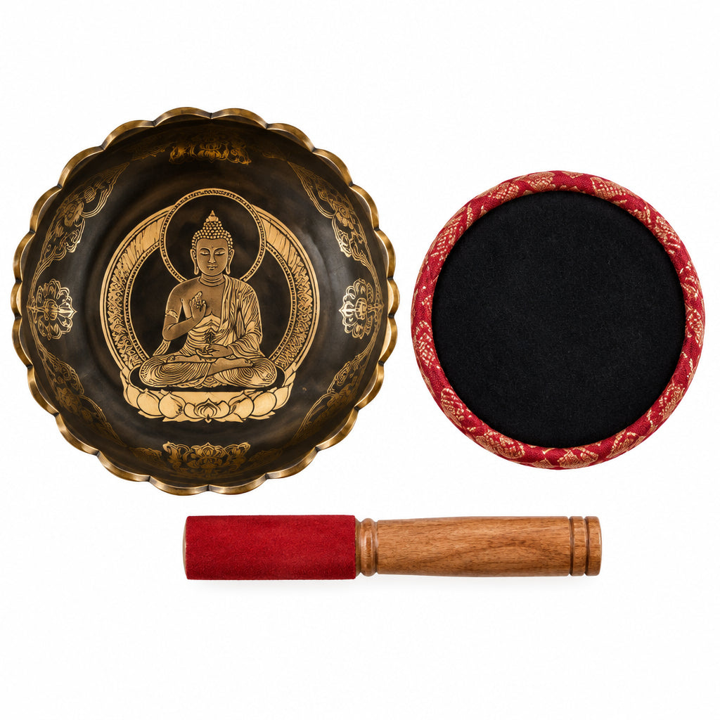 A compact, polished brass singing bowl sitting alongside a small dark wooden striker with carved decorative rings on a plain background.