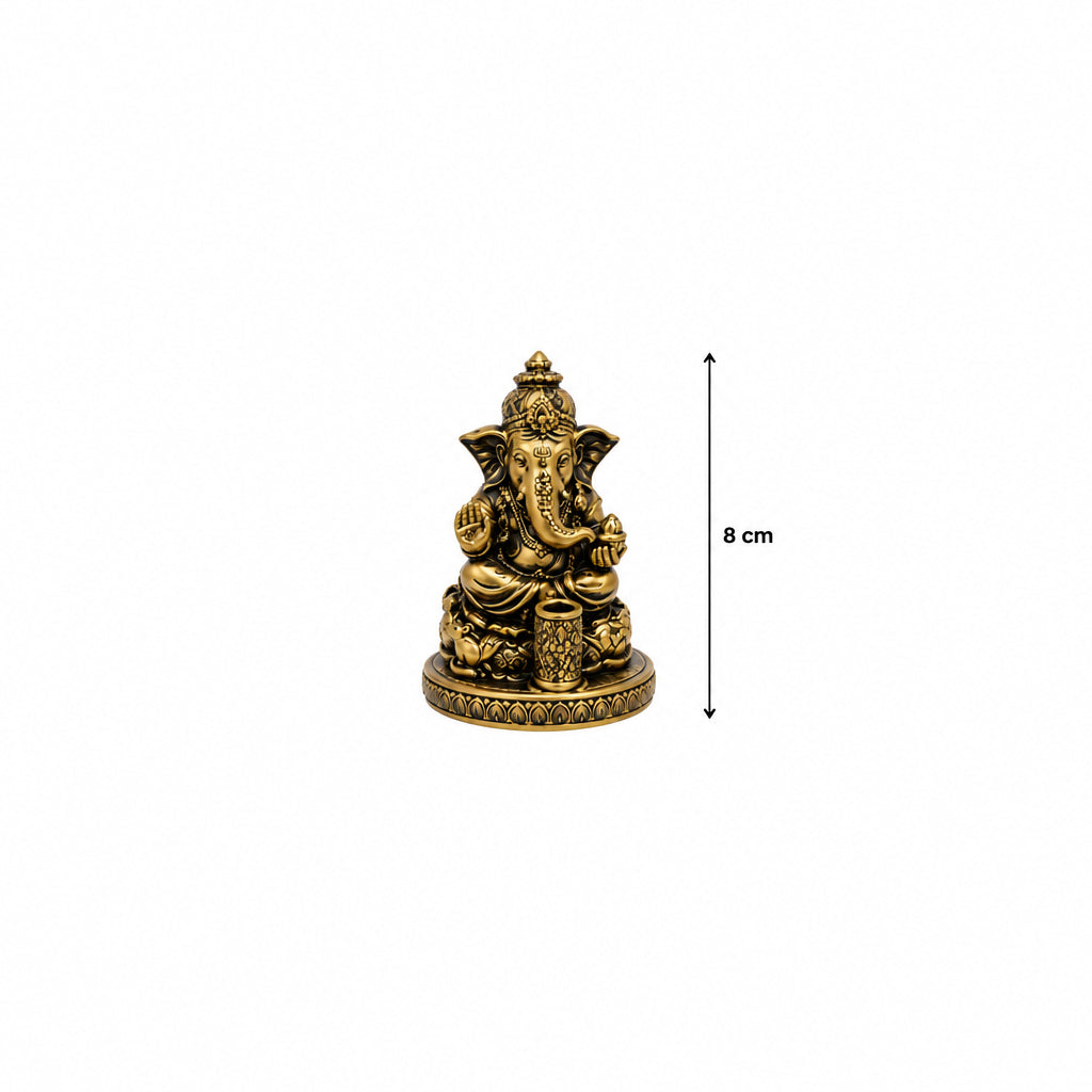 A small resin casting of Ganesh, the Hindu deity, in a golden finish, used as an incense holder. Approimately 8cm measurement.