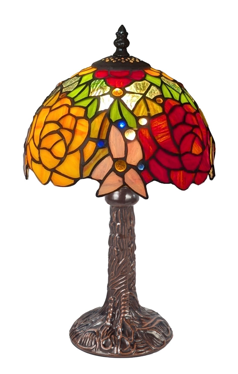 A Tiffany-style stained glass table lamp featuring a multicolor floral design with red, yellow, green, and peach glass panels, supported by a dark bronze tree-trunk base on a white background.