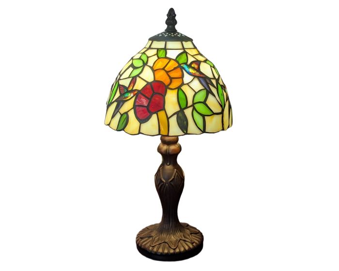 A Tiffany-style stained glass table lamp featuring a multicolor floral and bird design on a cream glass shade, with a dark bronze metal stem and base, shown against a plain white background.
