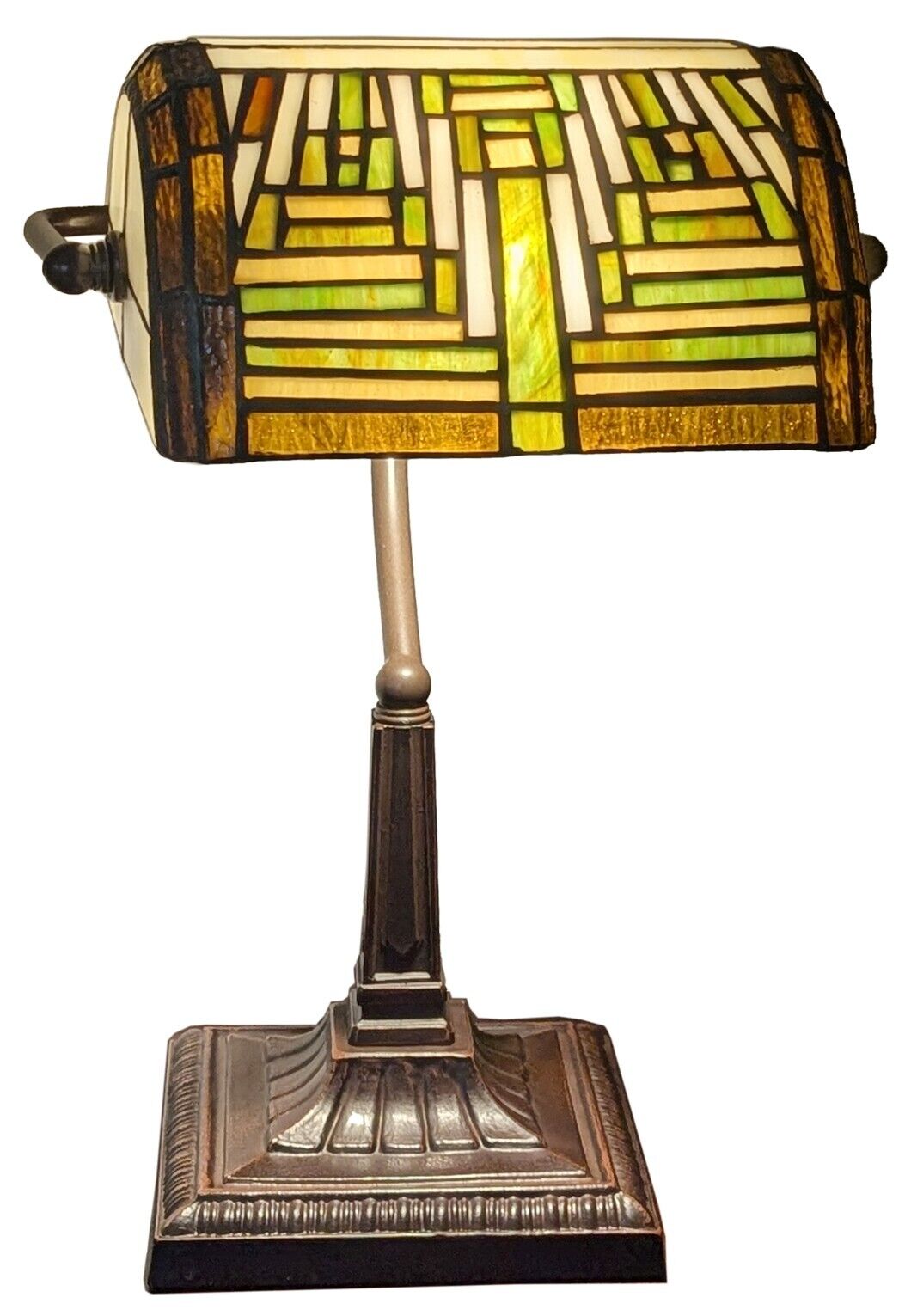 Decorative table lamp with stained glass shade on a white background