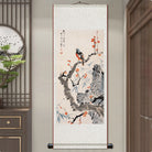 Traditional Chinese scroll painting of birds and flowers on a wall