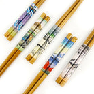 Set of decorative chopsticks with artistic wraps on a white background
