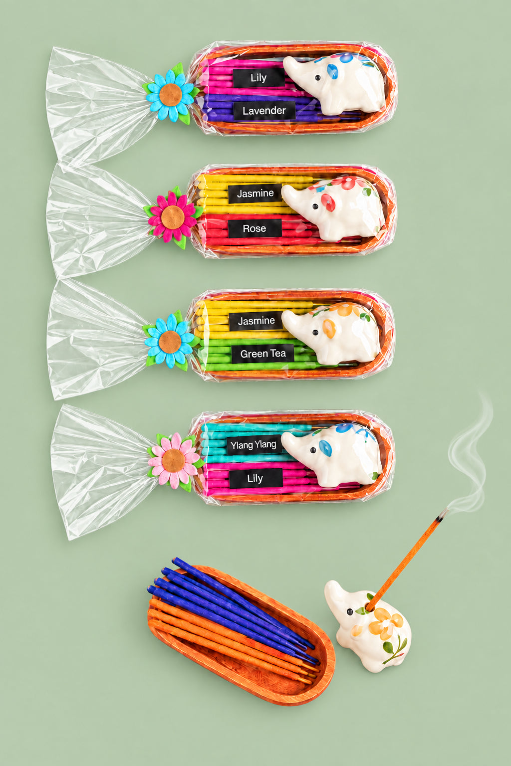 A set of colorful incense sticks with decorative flowers, placed in clear plastic trays, displayed against a sage background.