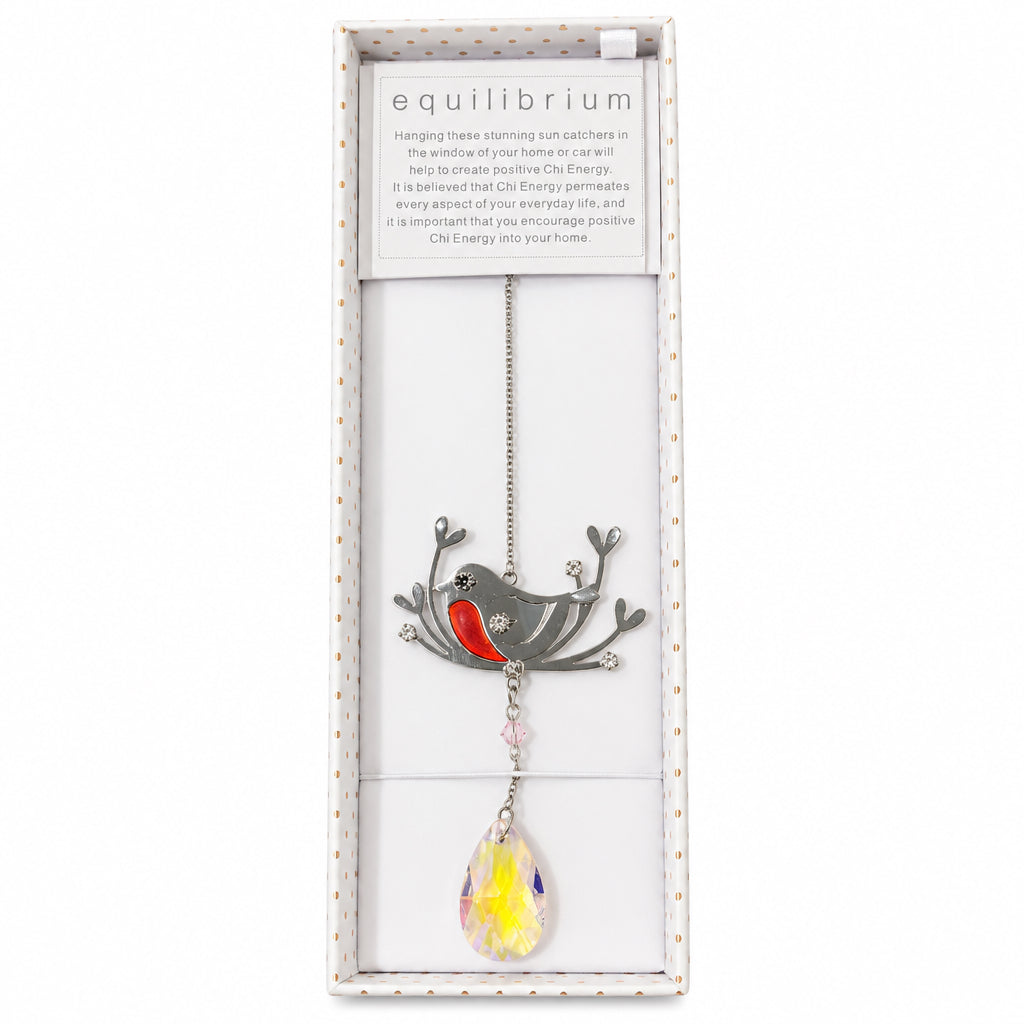 A hanging tree sun catcher in its original white presentation box. The sun catcher features a silver bird with a red chest, silver branches, and a dangling yellow and pink faceted crystal weight.