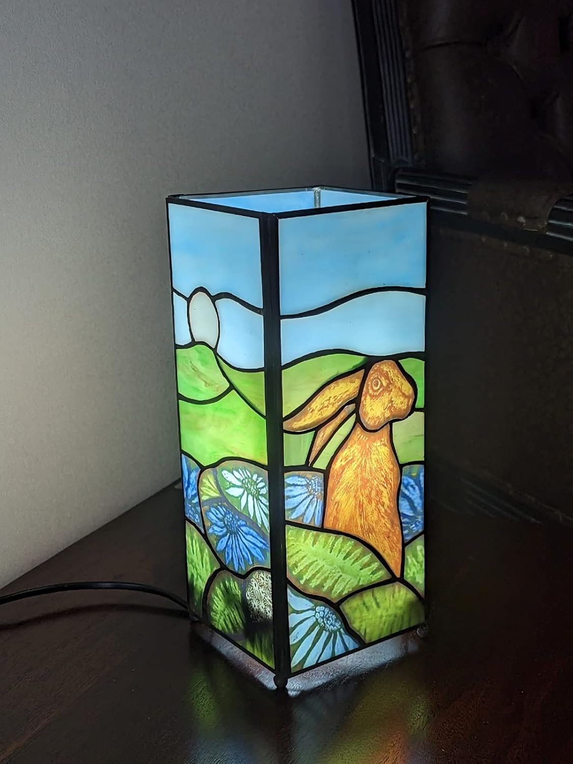 Rabbit design square Tiffany table lamp illuminated with stained glass depicting a hare in a field | stained glass