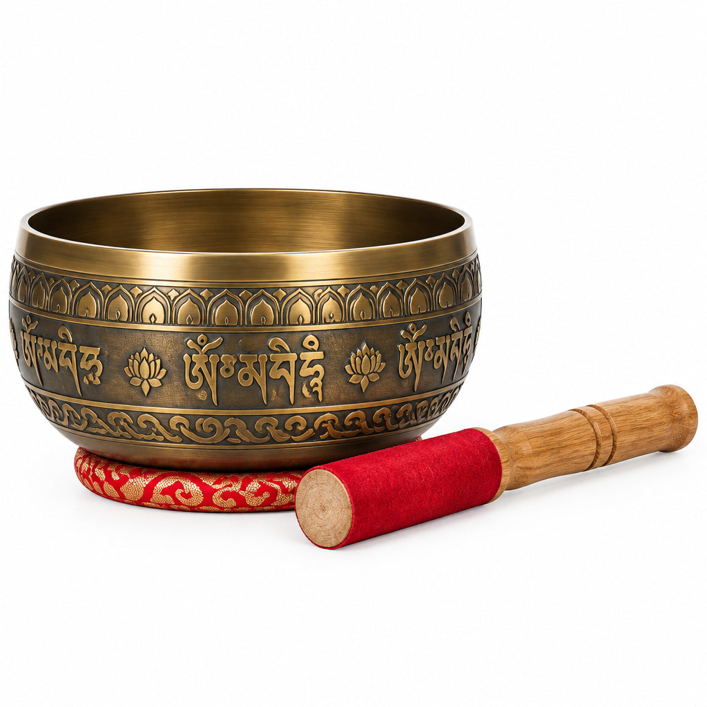A compact, polished golden brass singing bowl accompanied by a dark wooden striker, set against a plain white background.