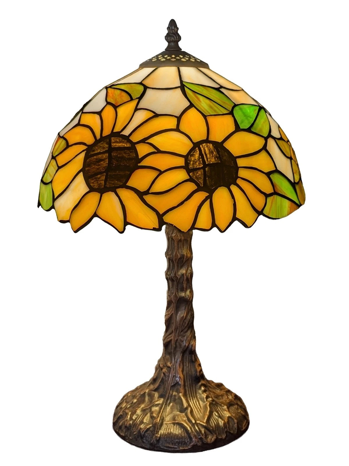 A Tiffany-style stained glass table lamp shaped like a sunflower, featuring yellow and orange petals, green leaves, and a dark brown textured stem and base on a white background.